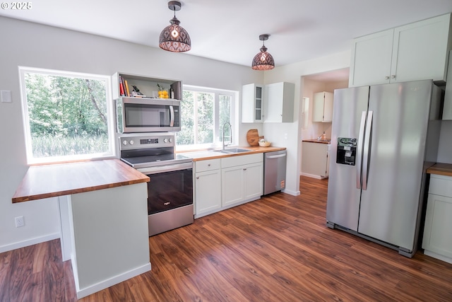28788 Gimpl Hill Rd, Eugene, OR 97402 - kitchen with stainless steel appliances, butcher block counters, a sink, white cabinetry, and dark wood finished floors