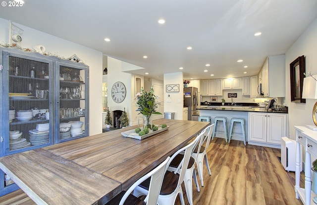 dining area with light wood-style floors and recessed lighting