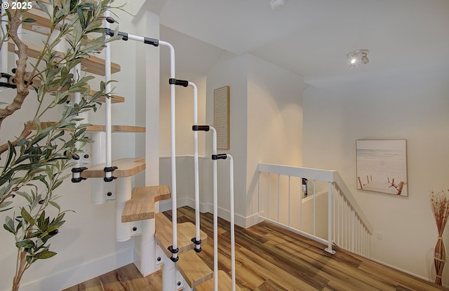 workout room with baseboards and wood finished floors