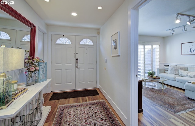 foyer with baseboards, dark wood-style flooring, recessed lighting, and track lighting