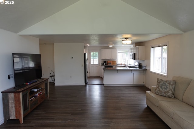1540 7th Dr, Hammond, OR 97121 - living room featuring dark wood-type flooring, healthy amount of natural light, baseboards, and high vaulted ceiling