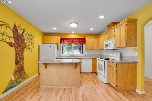 kitchen featuring a kitchen island, baseboards, recessed lighting, light wood-style floors, and white appliances