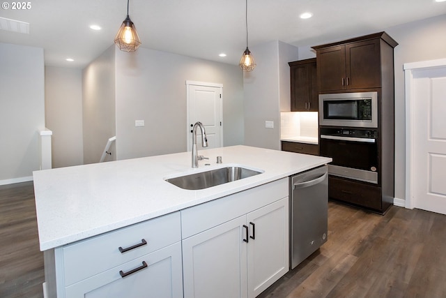 kitchen with white cabinetry, stainless steel appliances, sink, and pendant lighting