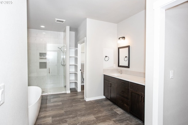 bathroom featuring independent shower and bath, vanity, and hardwood / wood-style flooring