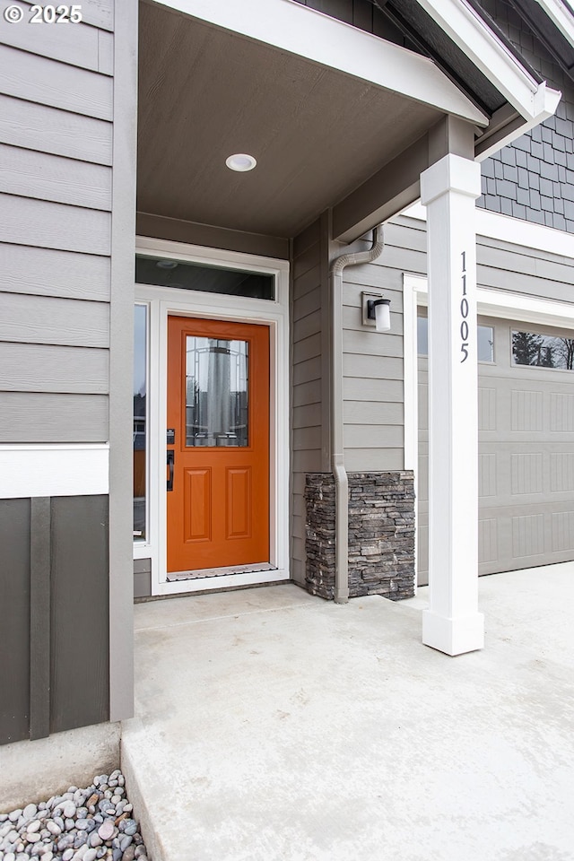 doorway to property with a garage