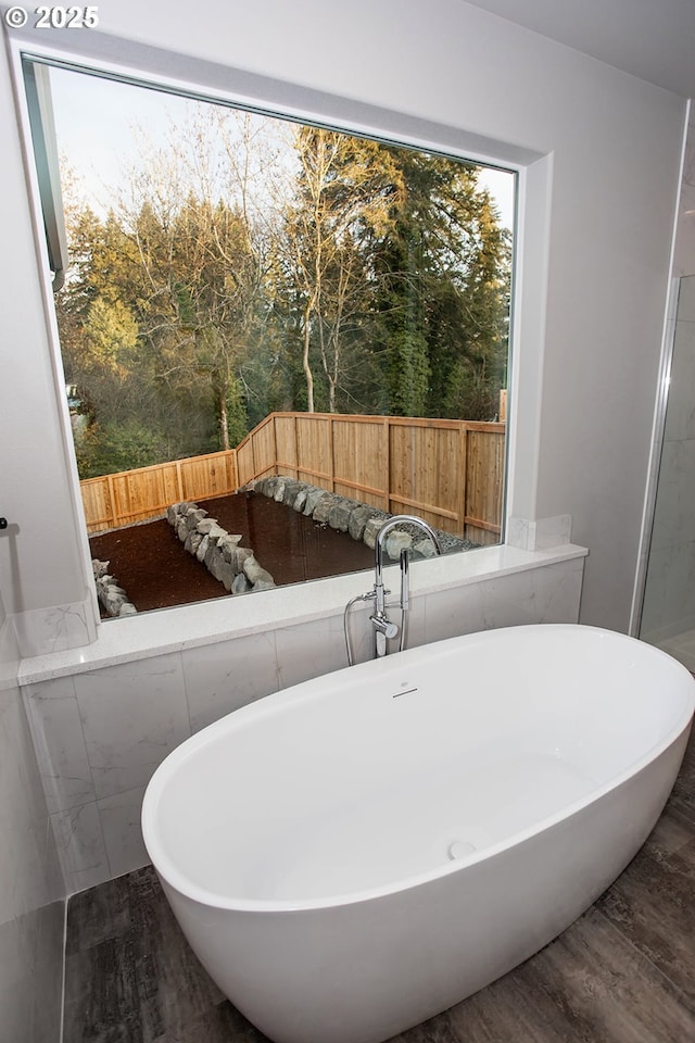 bathroom featuring hardwood / wood-style floors and a bathtub