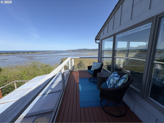 wooden deck featuring a water view