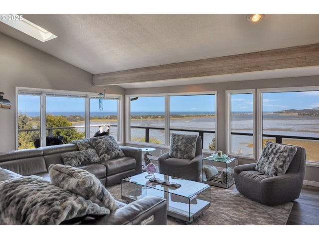 living room featuring a water view, recessed lighting, lofted ceiling with skylight, and wood finished floors