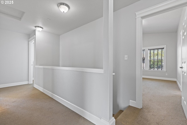 hall featuring light carpet and vaulted ceiling