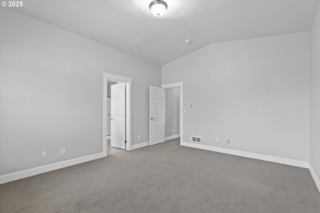 unfurnished bedroom featuring carpet and lofted ceiling