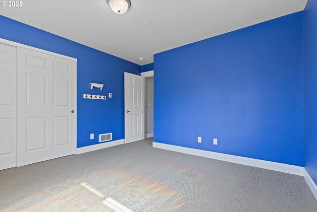 7115 NE Benton Pl, Newport, OR 97365 - unfurnished bedroom with carpet flooring, baseboards, and a closet
