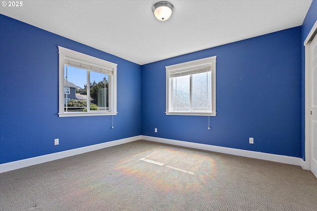 carpeted empty room featuring a healthy amount of sunlight