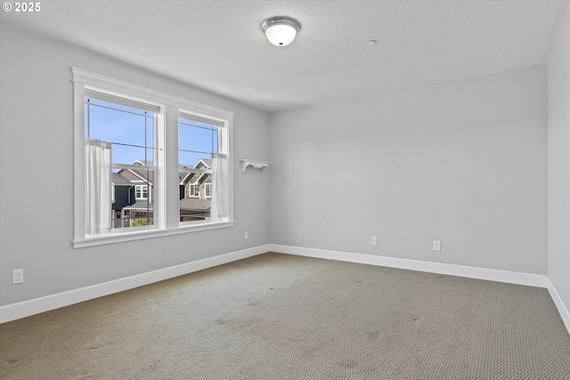 7115 NE Benton Pl, Newport, OR 97365 - empty room featuring carpet floors, baseboards, and a textured ceiling