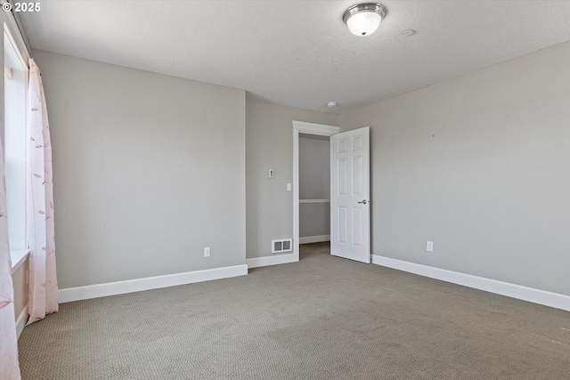 unfurnished bedroom featuring carpet floors and a textured ceiling