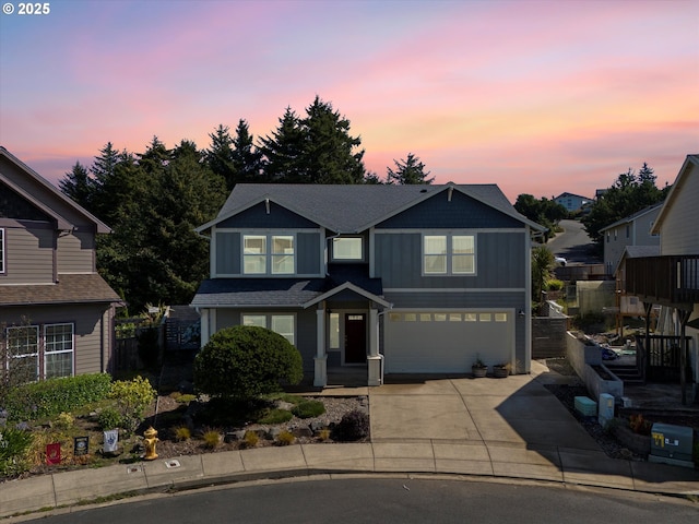 7115 NE Benton Pl, Newport, OR 97365 - view of front of house with concrete driveway, an attached garage, and board and batten siding