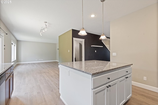 7115 NE Benton Pl, Newport, OR 97365 - kitchen with light wood-style floors, stainless steel dishwasher, baseboards, white cabinets, and light stone countertops
