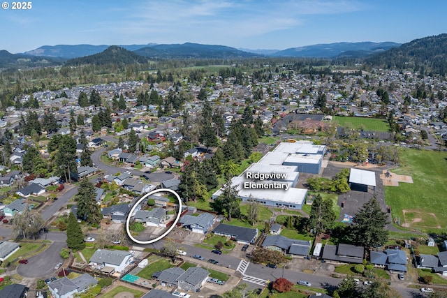 drone / aerial view featuring a residential view and a mountain view
