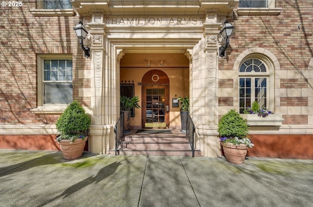 entrance to property with stone siding and brick siding