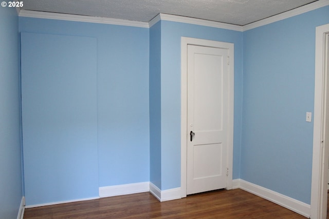 unfurnished bedroom with crown molding and dark wood-type flooring