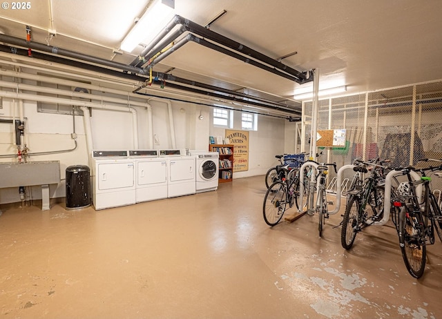 garage with bike storage, washer and clothes dryer, and a sink