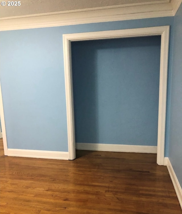 room details featuring baseboards and wood finished floors