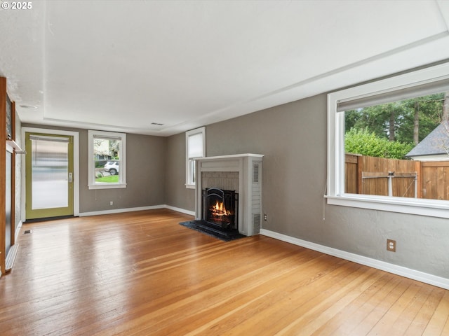 8978 SW Terreton Pl, Portland, OR 97223 - unfurnished living room with hardwood / wood-style flooring, a fireplace, and baseboards