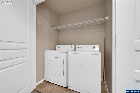 8465 S Hollyhock St, Rockaway Beach, OR 97136 - laundry room with tile patterned floors, washer and clothes dryer, and baseboards