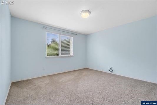 8465 S Hollyhock St, Rockaway Beach, OR 97136 - unfurnished room featuring carpet floors
