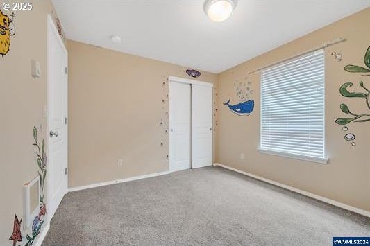 8465 S Hollyhock St, Rockaway Beach, OR 97136 - spare room with baseboards and carpet