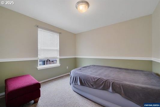 8465 S Hollyhock St, Rockaway Beach, OR 97136 - bedroom featuring baseboards and carpet floors