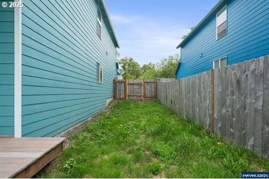 8465 S Hollyhock St, Rockaway Beach, OR 97136 - view of yard featuring a fenced backyard