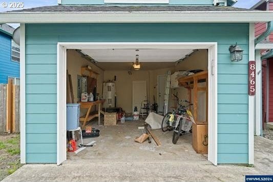 8465 S Hollyhock St, Rockaway Beach, OR 97136 - exterior space featuring a garage and fence