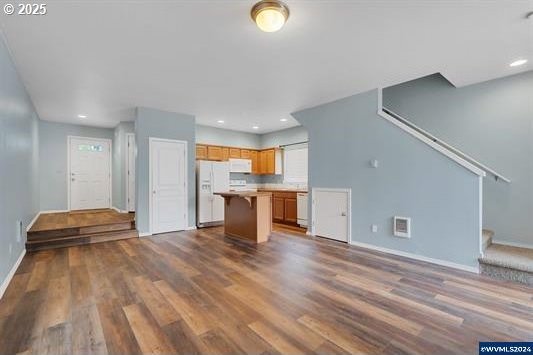 8465 S Hollyhock St, Rockaway Beach, OR 97136 - unfurnished living room featuring recessed lighting, baseboards, dark wood-style floors, and stairway