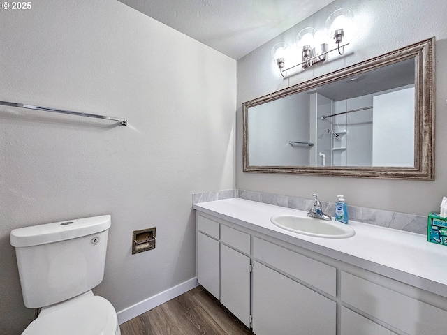 bathroom featuring vanity, toilet, and wood-type flooring