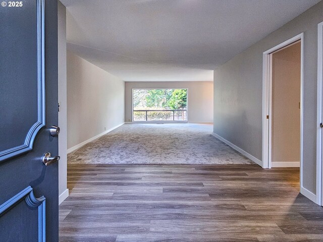 unfurnished bedroom with light hardwood / wood-style floors, access to exterior, a closet, and a brick fireplace