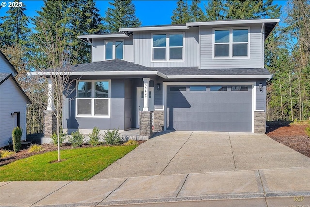 prairie-style house with a garage, stone siding, board and batten siding, and concrete driveway