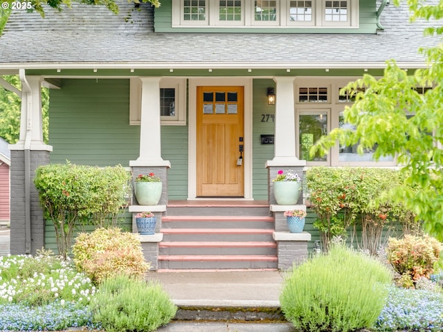 view of exterior entry featuring covered porch