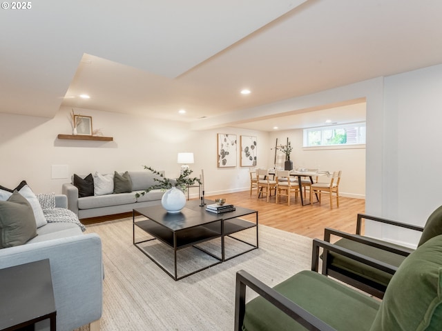 living room with light wood finished floors, recessed lighting, and baseboards