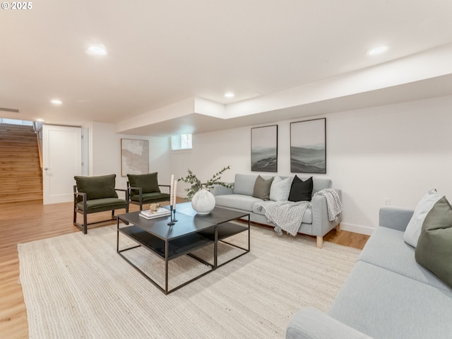 living room featuring light wood finished floors, stairway, recessed lighting, and baseboards