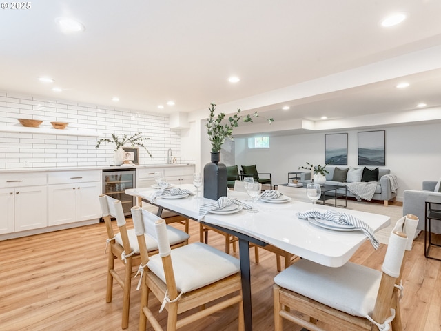 dining area with wine cooler, light wood-style floors, and recessed lighting