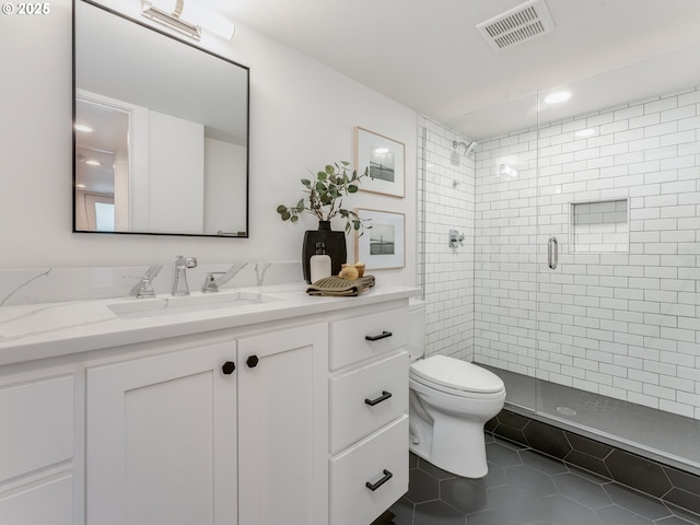 bathroom with toilet, a shower stall, tile patterned floors, vanity, and recessed lighting