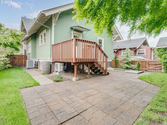 rear view of house with a patio area, a cooling unit, a deck, cooling unit, and a gate