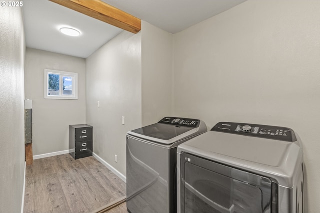 washroom with washer and dryer and light hardwood / wood-style floors