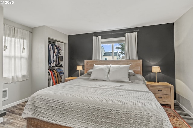 bedroom featuring hardwood / wood-style floors and a closet