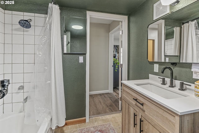 bathroom featuring shower / bathtub combination with curtain and vanity