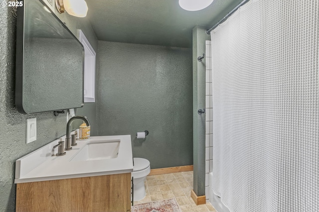 bathroom with toilet, vanity, and a shower with curtain