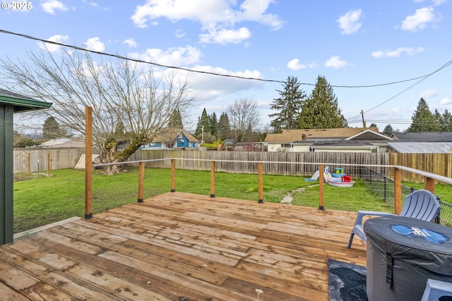 wooden terrace featuring a lawn