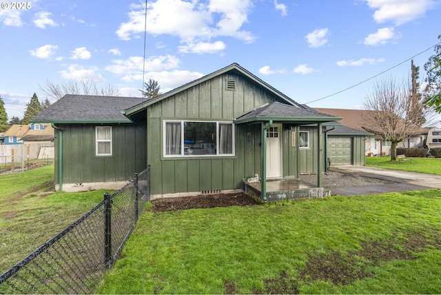 bungalow-style house with a front yard and a garage