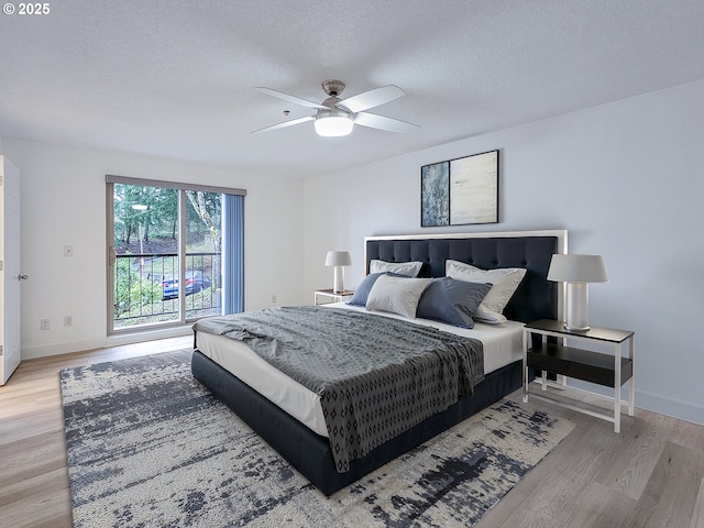 bedroom featuring baseboards, a ceiling fan, access to exterior, a textured ceiling, and light wood-style floors