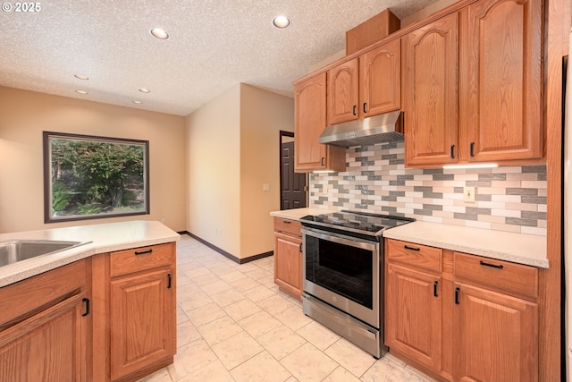 16402 SE Teal Ct, Damascus, OR 97089 - kitchen featuring electric range, under cabinet range hood, decorative backsplash, light countertops, and recessed lighting